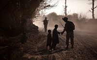 KUCHINEY DARVISHAN, Helmand province, Afghanistan — U.S. Marine Sgt. Jeremy Holsten, a 25-year-old squad leader with 3rd Platoon, Lima Company, 3rd Battalion, 3rd Marine Regiment and native of Albuquerque, greets local children during a partnered security patrol with Afghan National Army soldiers here, Dec. 18. On the patrol, the ANA and Marines interacted with local citizens and conducted a vehicle checkpoint.