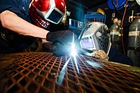 U.S. Navy Hull Maintenance Technician 3rd Class Dustin Lenhardt, left, and Hull Maintenance Technician 3rd Class Cody Eitniear weld in the sheet metal shop aboard the aircraft carrier USS John C. Stennis (CVN 74) in the Arabian Sea Jan. 8, 2012.