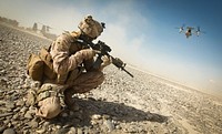 U.S. Marine Corps Cpl. William Cox, an armorer assigned to the Joint Sustainment Academy Southwest, holds an M4 carbine while providing security as an MV-22 Osprey takes off in support of Enduring Freedom in Zaranj, Nimroz province, Dec. 30, 2011.