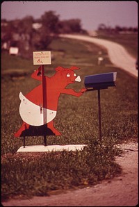 This little piggy minds the mail. (south of Wymore, on Route 77), May 1973. Photographer: O'Rear, Charles. Original public domain image from Flickr