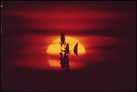 Farm windmill outlined against setting sun near Seward. Original public domain image from Flickr