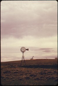 Windmill on the rolling ranch lands near Powder River Wyoming, 06/1973. Photographer: Norton, Boyd. Original public domain image from Flickr
