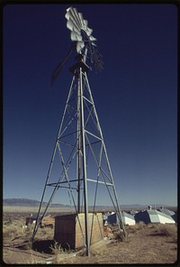 Windmill at a home near Albuquerque, New Mexico, is used to pump water for domestic use. Future plans include the use of wind energy for generating electricity in a solar heated home, 04/1974. Photographer: Norton, Boyd. Original public domain image from Flickr