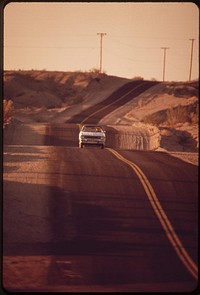 Highway through desert near Colorado River. Road is constructed in a series of dips as a protection against flash flooding, May 1972. Photographer: O'Rear, Charles. Original public domain image from Flickr