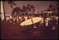 Tourists just off buses crowd premises outside waterfront hotel at Lahina. A few years ago this area was virtually empty, October 1973. Photographer: O'Rear, Charles. Original public domain image from Flickr