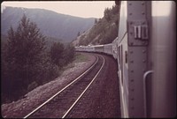 Westbound Empire Builder winds around the edge of Glacier National Park after leaving the East Glacier Park, Montana station, enroute to Spokane (Washington).