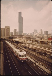 New Amtrak turboliner which now makes the passenger run between Chicago and St. Louis, Missouri, contrasts with the older "smoking" type engines which are now used less frequently than in the past, June 1974. Photographer: O'Rear, Charles. Original public domain image from Flickr