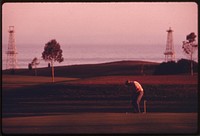 Oil derricks are located near the Sandpiper Golf Course, June 1975. Photographer: O'Rear, Charles. Original public domain image from Flickr