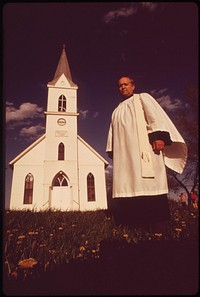 Rev. David T. Ernst in front of his church, the Immanuel Lutheran, in Plymouth. Church is 70 years old, May 1973. Photographer: O'Rear, Charles. Original public domain image from Flickr