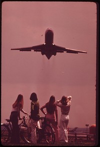 Bicyclist Holds Ears As Jet Aircraft Roars Off From National Airport. Nearby Are A Marina And A Waterfowl Sanctuary, May 1973. Original public domain image from Flickr