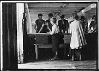 Interior of cutting shed. Young cutters at work, Clarence Goodell 8 years old, and Minnie Thomas, 9 years old. Eastport, Me, August 1911. Photographer: Hine, Lewis. Original public domain image from Flickr