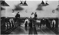 Photo of boys working in Arcade Bowling Alley. Photo taken late at night. The boys work until midnight and later. Trenton, N.J., December 1909. Photographer: Hine, Lewis. Original public domain image from Flickr