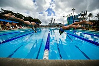 A U.S. Sailor and a New Zealand sailor compete in a Rim of the Pacific (RIMPAC) 2012 international swim meet at Scott Pool at Joint Base Pearl Harbor-Hickam, Hawaii, July 6, 2012.