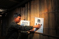 U.S. Navy Hospital Corpsman 3rd Class Michael Gonzales, with Marine Corps Battalion Landing Team, 3rd Battalion, 5th Marine Regiment, 15th Marine Expeditionary Unit (MEU), posts optometry charts at a school during exercise Crocodilo 2012 in a village in East Timor Oct. 11, 2012.