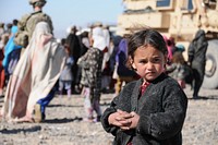 A young Farahi girl waits patiently to receive assistance during a visit to her village, Feb. 9. Provincial Reconstruction Team (PRT) Farah visited the returnee and refugee village on the outskirts of Farah City to conduct a site survey and deliver humanitarian assistance.