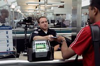 A CBP Officer processes an incoming passenger at the Newark International Airport.