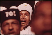 Religious Fervor is Mirrored on the Face of a Black Muslim Woman, One of Some 10,000 Listening to Elijah Muhammad Deliver His Annual Savior's Day Message In Chicago, 03/1974. Photographer: White, John H. Original public domain image from Flickr