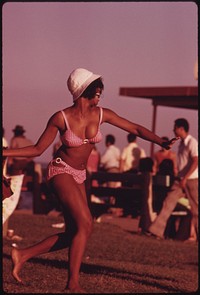 A Swimsuit Clad Black Woman Enjoys Her Summer Outing At Chicago's 12th Street Beach On Lake Michigan, 08/1973. Photographer: White, John H. Original public domain image from Flickr