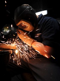 U.S. Navy Hull Maintenance Technician Fireman George Weckman fabricates a coat rack in the weld shop aboard the aircraft carrier USS Nimitz (CVN 68) June 5, 2013, while underway in the Indian Ocean.