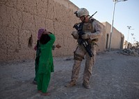 U.S. Marine Corps Cpl. Rodney Altamaranio, right, assigned to Combined Anti-Armor Team 1, 3rd Battalion, 4th Marine Regiment, talks to Afghan children during a joint vehicle checkpoint with Afghan National Army soldiers in Now Zad, Helmand province, Afghanistan, May 27, 2013.