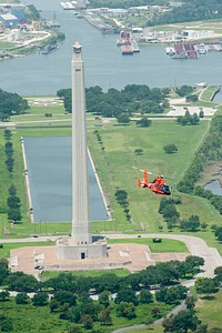 U.S. Coast Guardsmen pass the San Jacinto Monument during a training flight aboard an MH-65D Dolphin helicopter over the Houston Ship Channel July 25, 2013.