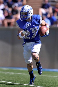 Ty MacArthur, a senior football player for the U.S. Air Force Academy Falcons, runs the ball down the field during a football game against the Utah State Aggies at Falcon Stadium in Colorado Springs, Colo., as the conference rivals meet Sept. 7, 2013.
