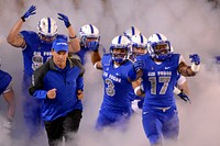 U.S. Air Force Academy Falcons head coach Troy Calhoun leads the team into the stadium, as Air Force met conference rival Wyoming, at Falcon Stadium in Colorado Springs, Colo., Sept. 21, 2013.