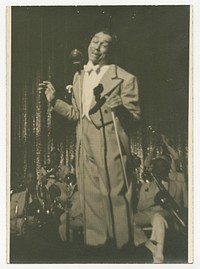 Print of Cab Calloway in checked suit standing in front of microphone, National Museum of African American History and Culture