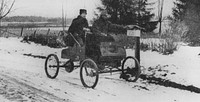 Photograph of rural carrier in automobile at mailbox