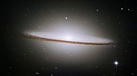 The famous Sombrero galaxy (M104) is a bright nearby elliptical galaxy. The prominent dust lane and halo of stars and globular clusters give this galaxy its name. Something very energetic is going on in the Sombrero's center, as much X-ray light has been detected from it. This X-ray emission coupled with unusually high central stellar velocities cause many astronomers to speculate that a black hole lies at the Sombrero's center - a black hole a billion times the mass of our Sun.