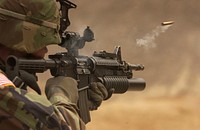 A shell casing flies out with a trail of smoke as U.S. Army Pfc. Michael Freise fires an M-4 rifle during a reflex firing exercise at the Rodriguez Live Fire Complex, Republic of Korea, on March 23, 2005. Freise is attached to the 1st Battalion, 72nd Armor Regiment, which is taking part in exercises Reception, Staging, Onward movement, and Integration/Foal Eagle. The annual, multi-phase exercise is tailored to train, test, and demonstrate U.S. and Republic of Korea force projection and deployment capabilities.