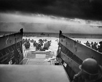 A LCVP (Landing Craft, Vehicle, Personnel) from the U.S. Coast Guard-manned USS Samuel Chase disembarks troops of Company A, 16th Infantry, 1st Infantry Division (the Big Red One) wading onto the Fox Green section of Omaha Beach (Calvados, Basse-Normandie, France) on the morning of June 6, 1944. American soldiers encountered the newly formed German 352nd Division when landing. During the initial landing two-thirds of Company E became casualties.