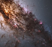 Resembling looming rain clouds on a stormy day, dark lanes of dust crisscross the giant elliptical galaxy Centaurus A.Hubble's panchromatic vision, stretching from ultraviolet through near-infrared wavelengths, reveals the vibrant glow of young, blue star clusters and a glimpse into regions normally obscured by the dust.The warped shape of Centaurus A's disk of gas and dust is evidence for a past collision and merger with another galaxy. The resulting shockwaves cause hydrogen gas clouds to compress, triggering a firestorm of new star formation. These are visible in the red patches in this Hubble close-up.At a distance of just over 11 million light-years, Centaurus A contains the closest active galactic nucleus to Earth. The center is home for a supermassive black hole that ejects jets of high-speed gas into space, but neither the supermassive black hole nor the jets are visible in this image.This image was taken in July 2010 with Hubble's Wide Field Camera 3.