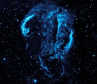 Wispy tendrils of hot dust and gas glow brightly in this ultraviolet image of the Cygnus Loop Nebula, taken by NASA’s Galaxy Evolution Explorer. The nebula lies about 1,500 light-years away, and is a supernova remnant, left over from a massive stellar explosion that occurred 5,000-8,000 years ago. The Cygnus Loop extends more than three times the size of the full moon in the night sky, and is tucked next to one of the 'swan’s wings' in the constellation of Cygnus. The filaments of gas and dust visible here in ultraviolet light were heated by the shockwave from the supernova, which is still spreading outward from the original explosion. The original supernova would have been bright enough to be seen clearly from Earth with the naked eye.