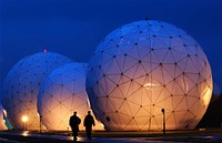 Boatswain's Mate Second Class Donald Rouse and Air Force Airman John Yorde make early morning security rounds by the radomes at the Cryptologic Operations Center, Misawa, Japan.