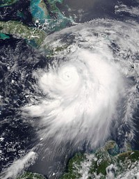 Hurricane Dennis threaded its way between Jamaica and Haiti on a direct course for Cuba on July 7, 2005. The storm now has the distinctive hurricane form, with a well-defined eye surrounded by bands of swirling clouds. At 10:50 a.m. local time (15:50 UTC), when the Moderate Resolution Imaging Spectroradiometer (MODIS) on NASA's Terra satellite took this image, Dennis was just below a Category 3 hurricane, with winds of 175 kilometers per hour (110 miles per hour) and stronger gusts. Less than an hour before this image was taken, the storm's small dark eye was about 105 kilometers (65 miles) northeast of Kingston, Jamaica, and 170 kilometers (105 miles) south-southeast of Guantanamo, Cuba. The National Hurricane Center reports that Dennis is traveling northwest at about 24 kilometers per hour (15 mph).A storm of this size is a threat not just because of its powerful winds: Dennis is expected to produce heavy rain and coastal and inland flooding. Five to ten inches of rain may fall over Haiti, the Dominican Republic, Jamaica, Cuba, and the Cayman Islands, with as much as 15 inches falling in parts of Jamaica. Heavy rainfall can trigger flash floods and mudslides in mountainous regions. The storm will probably also raise tide levels by five to seven feet and generate large and dangerous waves.Dennis is expected to strengthen as it moves north towards the Gulf Coast of the United States. For official storm warnings and additional information, please visit the National Hurricane Center.The image is available in additional resolutions from the MODIS Rapid Response Team.