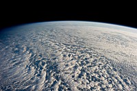 Stratocumulus clouds above the northwestern Pacific Ocean, about 460 miles east of northern Honshu, Japan. This is a descending pass with a panoramic view looking southeast in late afternoon light with the terminator (upper left). The cloud pattern is typical for this part of the world. The low clouds carry cold air over a warmer sea with no discernable storm pattern.ISS Crew Earth Observations: ISS034-E-016601IdentificationMissionISS034 (Expedition 34)RollEFrame016601CameraCamera Focal Length24 mmCameraNikon D3SQualityPercentage of Cloud Cover76-100%NadirWhat is Nadir?Date2013-01-04Time05:56:04Original image captionOn Jan. 4 a large presence of stratocumulus clouds was the central focus of camera lenses which remained aimed at the clouds as the Expedition 34 crew members aboard the International Space Station flew above the northwestern Pacific Ocean about 460 miles east of northern Honshu, Japan. This is a descending pass with a panoramic view looking southeast in late afternoon light with the terminator (upper left). The cloud pattern is typical for this part of the world. The low clouds carry cold air over a warmer sea with no discernable storm pattern.
