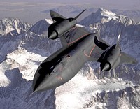 The SR-71B Blackbird, flown by the Dryden Flight Research Center as NASA 831, slices across the snow-covered southern Sierra Nevada Mountains of California after being refueled by an Air Force tanker during a 1994 flight. SR-71B was the trainer version of the SR-71. Notice the dual cockpit to allow the instructor to fly the airplane.