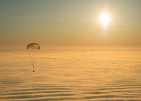 On March 12, 2015, shortly after local sunrise over central Asia, this Soyuz TMA-14M spacecraft floated over a sea of golden clouds during its descent by parachute through planet Earth's dense atmosphere. On board were Expedition 42 commander Barry Wilmore of NASA and Alexander Samokutyaev and Elena Serova of the Russian Federal Space Agency (Roscosmos). Touch down was at approximately 10:07 p.m. EDT (8:07 a.m. March 12, Kazakh time) southeast of Zhezkazgan, Kazakhstan. The three were returning from low Earth orbit, after almost six months on the International Space Station as members of the Expedition 41 and Expedition 42 crews.