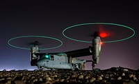 Crew members refuel an A V-22 Osprey before a night mission in central Iraq.