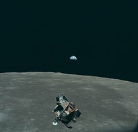 Earth, Moon and Lunar Module, in lunar orbit after return from the moon and before rendezvous with the Apollo 11 Command/Service Module. Mars is visible as the red dot on the right-hand side of Earth. AS11-44-6643.