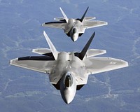 Lt. Col. James Hecker (front) and Lt. Col. Evan Dertein line up their F/A-22 Raptor aircraft behind a KC-10 Extender to refuel while en route to Hill Air Force Base, Utah. Colonel Hecker commands the first operational Raptor squadron -- the 27th Fighter Squadron at Langley Air Force Base, Va. The unit went to Hill for operation Combat Hammer, the squadron's first deployment, Oct. 15. The deployment has a twofold goal: complete a deployment and to generate a combat-effective sortie rate away from home. [U.S. Air Force photo by TSgt Ben Bloker]