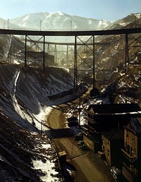 Carr Fork Canyon as seen from "G" bridge, Bingham Copper Mine, Utah. In the background can be seen a train with waste or over-burden material on its way to the dump.