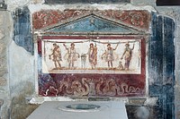 The thermopolium of Lucius Vetutius Placidus in Pompeii, focus on the lararium. Italy.