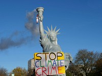 Statue of Liberty with smoky flame and protest text 'Stop Climate Crime', demonstration in Bonn, a few days before 2017 United Nations Climate Change Conference.
