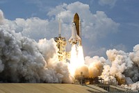 Original caption from Nasa: "CAPE CANAVERAL, Fla. – Sandwiched by billowing clouds above and smoke and steam clouds below, space shuttle Atlantis hurtles past the lightning mast on top of the fixed service structure on Launch Pad 39A at NASA's Kennedy Space Center in Florida. Atlantis will rendezvous with NASA's Hubble Space Telescope on the STS-125 service mission. Liftoff was on-time at 2:01 p.m. EDT. Atlantis' 11-day flight will include five spacewalks to refurbish and upgrade the telescope with state-of-the-art science instruments that will expand Hubble's capabilities and extend its operational lifespan through at least 2014. The payload includes a Wide Field Camera 3, Fine Guidance Sensor and the Cosmic Origins Spectrograph."