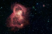 This image taken by NASA's Spitzer Space Telescope reveals the stellar nursery W40 (also known as Sh2-64) in infrared light. A young cluster of several hundred stars is located at the center of the nebula, and the stellar winds and radiation coming from these stars have blown bubbles in the surrounding gas. The expanding bubbles have produced the "butterfly" shape as seen in the image. Spitzer's IRAC camera took this mid-infrared image in the bands 8.0 micron, 5.8 micron, 4.5 micron, and 3.6 micron, here represented as red, orange, green, and blue.