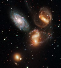 Galactic Wreckage in Stephan's QuintetA clash among members of a famous galaxy quintet reveals an assortment of stars across a wide color range, from young, blue stars to aging, red stars.This portrait of Stephan's Quintet, also known as Hickson Compact Group 92, was taken by the new Wide Field Camera 3 (WFC3) aboard NASA's Hubble Space Telescope. Stephan's Quintet, as the name implies, is a group of five galaxies. The name, however, is a bit of a misnomer. Studies have shown that group member NGC 7320, at upper left, is actually a foreground galaxy about seven times closer to Earth than the rest of the group.Three of the galaxies have distorted shapes, elongated spiral arms, and long, gaseous tidal tails containing myriad star clusters, proof of their close encounters. These interactions have sparked a frenzy of star birth in the central pair of galaxies. This drama is being played out against a rich backdrop of faraway galaxies.The image, taken in visible and near-infrared light, showcases WFC3's broad wavelength range.The colors trace the ages of the stellar populations, showing that star birth occurred at different epochs, stretching over hundreds of millions of years. The camera's infrared vision also peers through curtains of dust to see groupings of stars that cannot be seen in visible light.NGC 7319, at top right, is a barred spiral with distinct spiral arms that follow nearly 180 degrees back to the bar. The blue specks in the spiral arm at the top of NGC 7319 and the red dots just above and to the right of the core are clusters of many thousands of stars. Most of the quintet is too far away even for Hubble to resolve individual stars.Continuing clockwise, the next galaxy appears to have two cores, but it is actually two galaxies, NGC 7318A and NGC 7318B. Encircling the galaxies are young, bright blue star clusters and pinkish clouds of glowing hydrogen where infant stars are being born. These stars are less than 10 million years old and have not yet blown away their natal cloud. Far away from the galaxies, at right, is a patch of intergalactic space where many star clusters are forming.NGC 7317, at bottom left, is a normal-looking elliptical galaxy that is less affected by the interactions.Sharply contrasting with these galaxies is the dwarf galaxy NGC 7320 at upper left. Bursts of star formation are occurring in the galaxy's disk, as seen by the blue and pink dots. In this galaxy, Hubble can resolve individual stars, evidence that NGC 7320 is closer to Earth.NGC 7320 is 40 million light-years from Earth. The other members of the quintet reside 290 million light-years away in the constellation Pegasus.These farther members are markedly redder than the foreground galaxy, suggesting that older stars reside in their cores. The stars' light also may be further reddened by dust stirred up in the encounters.Spied by Edouard M. Stephan in 1877, Stephan's Quintet is the first compact group ever discovered.WFC3 observed the quintet in July and August 2009. The composite image was made by using filters that isolate light from the blue, green, and infrared portions of the spectrum, as well as emission from ionized hydrogen.These Hubble observations are part of the Hubble Servicing Mission 4 Early Release Observations. NASA astronauts installed the WFC3 camera during a servicing mission in May to upgrade and repair the 19-year-old Hubble telescope.