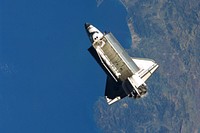 Seen over the Mediterranean Sea, near the Algerian coast (Skikda city), the space shuttle Atlantis is featured in this image photographed by the Expedition 21 crew on the International Space Station soon after the shuttle and station began their post-undocking separation. Undocking of the two spacecraft occurred at 3:53 a.m. (CST) on Nov. 25, 2009.