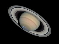 Photomontage of Saturn with a false-colour image of ultraviolet aurora taken with the Imaging Spectrograph on January 24 superimposed on an image of visible light taken with the Advanced Camera for Surveys on March 22, 2004 from NASA's Hubble Space Telescope